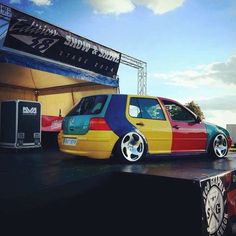 a colorful car parked in front of a stage