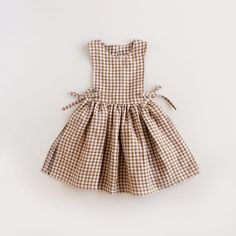 a brown and white checkered dress on a white background