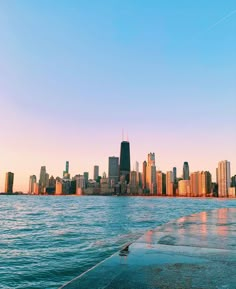 the city skyline is seen from across the water