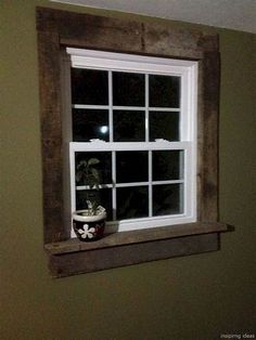 a window with a potted plant on the ledge next to it in a green room