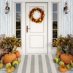 a front porch with pumpkins and gourds