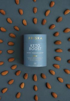 a can of friskka keto booster surrounded by almonds on a grey background