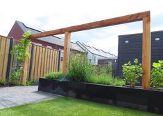 an outdoor garden with wooden posts and plants