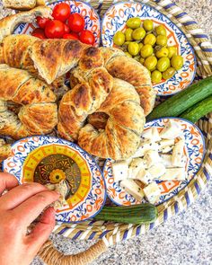 there is a platter with bread, olives, and other food on it