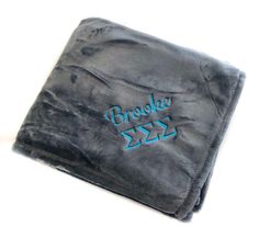 a black and blue blanket with the words breaky jazz on it's side