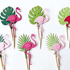 flamingo cupcake toppers with palm leaves and pink flamingos on them are ready to be cut