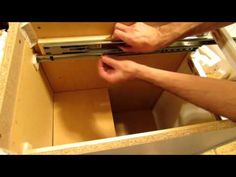 a man is opening the drawer with his hands