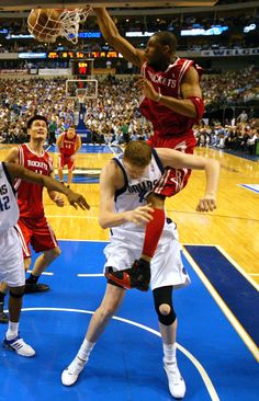 a group of men on a court playing basketball