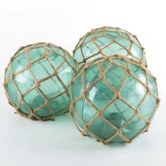 three green marble balls with rope wrapped around them