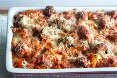 a casserole dish filled with meat and cheese