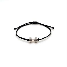 a black cord bracelet with two silver beads