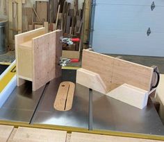 two pieces of wood sitting on top of a piece of metal in a garage area