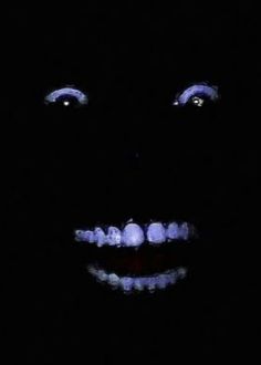 an image of a creepy face in the dark with teeth and glowing lights on it