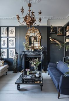 a living room filled with furniture and a chandelier