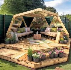 a wooden gazebo sitting on top of a lush green field with lots of plants