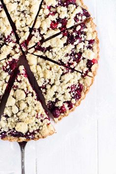 a pie with crumbled toppings on top and a fork in the middle