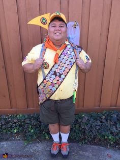 a young boy wearing a costume made to look like a pikachu holding a kite