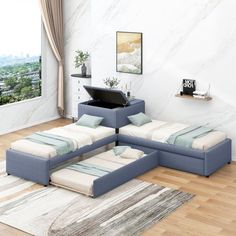 a living room filled with furniture on top of a hard wood floor covered in white and blue