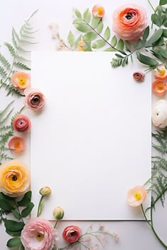 an empty paper surrounded by flowers and greenery on a white background with copy space