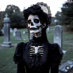 a woman with skeleton makeup in a cemetery