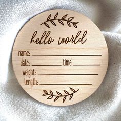 a wooden ornament with the words hello world written on it and an arrow