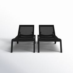 two black chairs sitting next to each other on a white surface with one chair facing the other