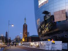 a tall building sitting next to a street filled with traffic