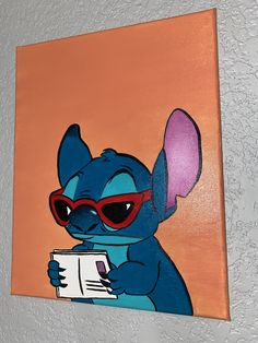 a painting of an elephant wearing sunglasses and reading a book on the wall above it