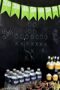 a football themed birthday party with cupcakes, drinks and decorations on a chalkboard background