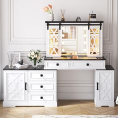 a white desk topped with a mirror and drawers