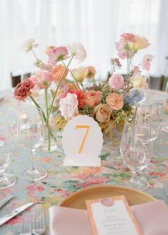 the table is set with pink and white flowers