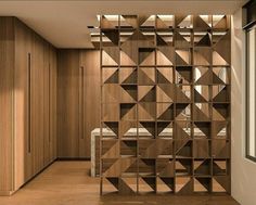 a room with wooden shelves filled with books