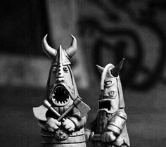 two figurines with horns and faces on them