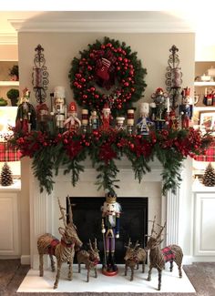 a mantel decorated with christmas decorations and deer figurines