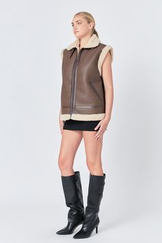 Bundle up in style with our Sherpa Lined Faux Leather Vest. Its oversized fit and belted design add a touch of edginess to any outfit. Featuring a front zipper closure and practical pockets, you'll stay warm and look chic. Hand wash cold to maintain its faux leather look. This versatile outerwear is perfect for layering and elevating your fashion game. Get the best of both worlds with our Sherpa Lined Faux Leather Vest - luxurious and affordable. Shop now for your new go-to piece that will keep Knitwear Trends, Jumpsuit Fall, Knit Loungewear, Faux Leather Vest, Strapless Bodycon Dress, Blazer And Shorts, Geek Chic, Leather Vest, Leather Dresses