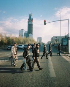 several people crossing the street at an intersection