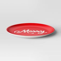 a red and white merry plate with the word merry written in cursive font