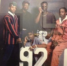 three men are posing for a photo in front of a large number 22 sign that reads 2 p2