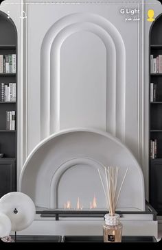 a living room filled with furniture and a fire place next to a book shelf full of books