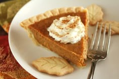 a slice of pie on a plate with whipped cream and crackers next to it