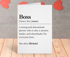 a card that says boss on it with hearts hanging from the string behind it and two red paper hearts