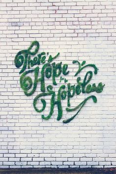 there is a brick wall with graffiti on it that says, there's more to happiness