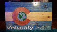 a wooden sign with the word velo city painted on it