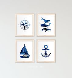 four blue and white art prints with boats, an anchor, whale, and compass