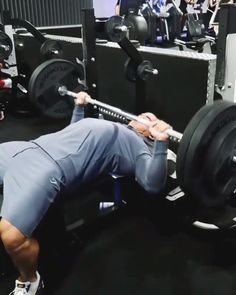 a man is doing squats with a barbell