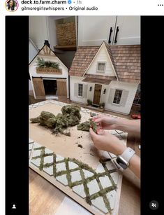 someone is decorating a house with fake moss