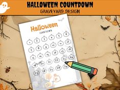 a sheet of paper with a pencil on it next to a pumpkin themed calendar for halloween