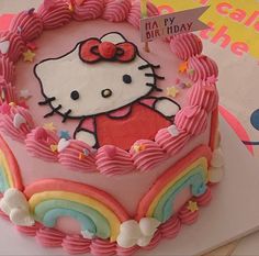 a hello kitty birthday cake on a table