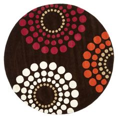 a brown and red rug with circles on it