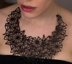 "This showstopper shiny black necklace is sure to make any outfit POP! Black acrylic plexiglass bib necklace laser cut with a tessellated design based on master origami artist (and our dear friend) Christine Edison's triangle box crease pattern. Bib necklace is approximately 8\" across at its widest dimension. Hung on silver-plated brass chain. See our other listing for iridescent acrylic plexiglass. Other colors and materials by request.  Please note that this material is fragile and should be Silouette Necklace, Black Geometric Jewelry, Modern Black Geometric Necklace, Geometric Black Necklace For Gift, Black Laser Cut Jewelry As Gift, Black Laser Cut Jewelry Gift, Black Geometric Necklace For Gift, Iridescent Acrylic, 3d Printing Fashion